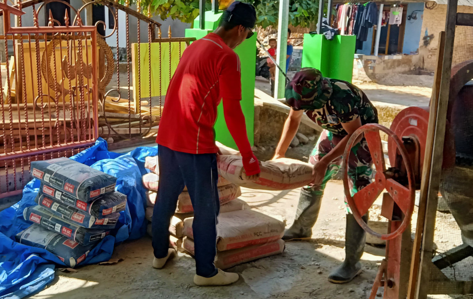 Prada Achmad Satgas TMMD ke 121 Bersama Warga Panggul Semen Untuk Bahan Campuran Keramik MWK